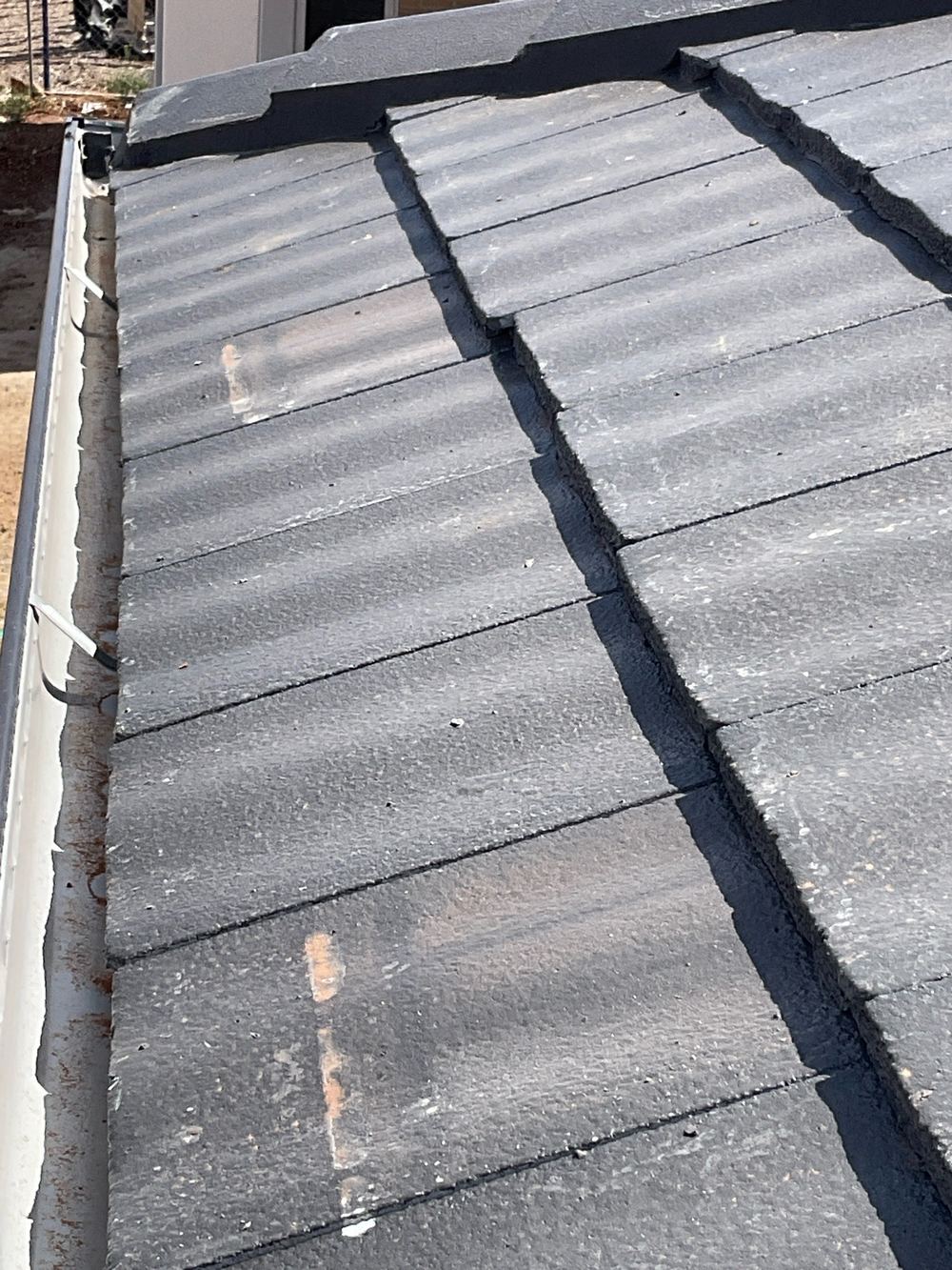 Roof tiles sitting out of position and at risk of slipping, found during a lock-up inspection in Aintree