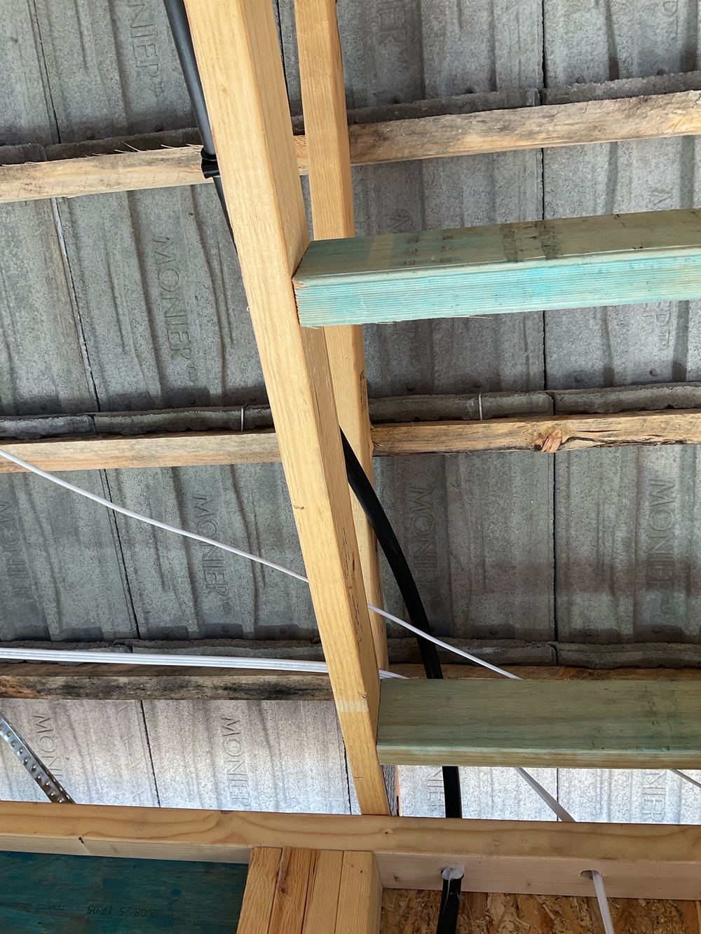 Plumbing pipes not clipped to the frame, free to rattle and shift, found during a lock-up inspection in Aintree