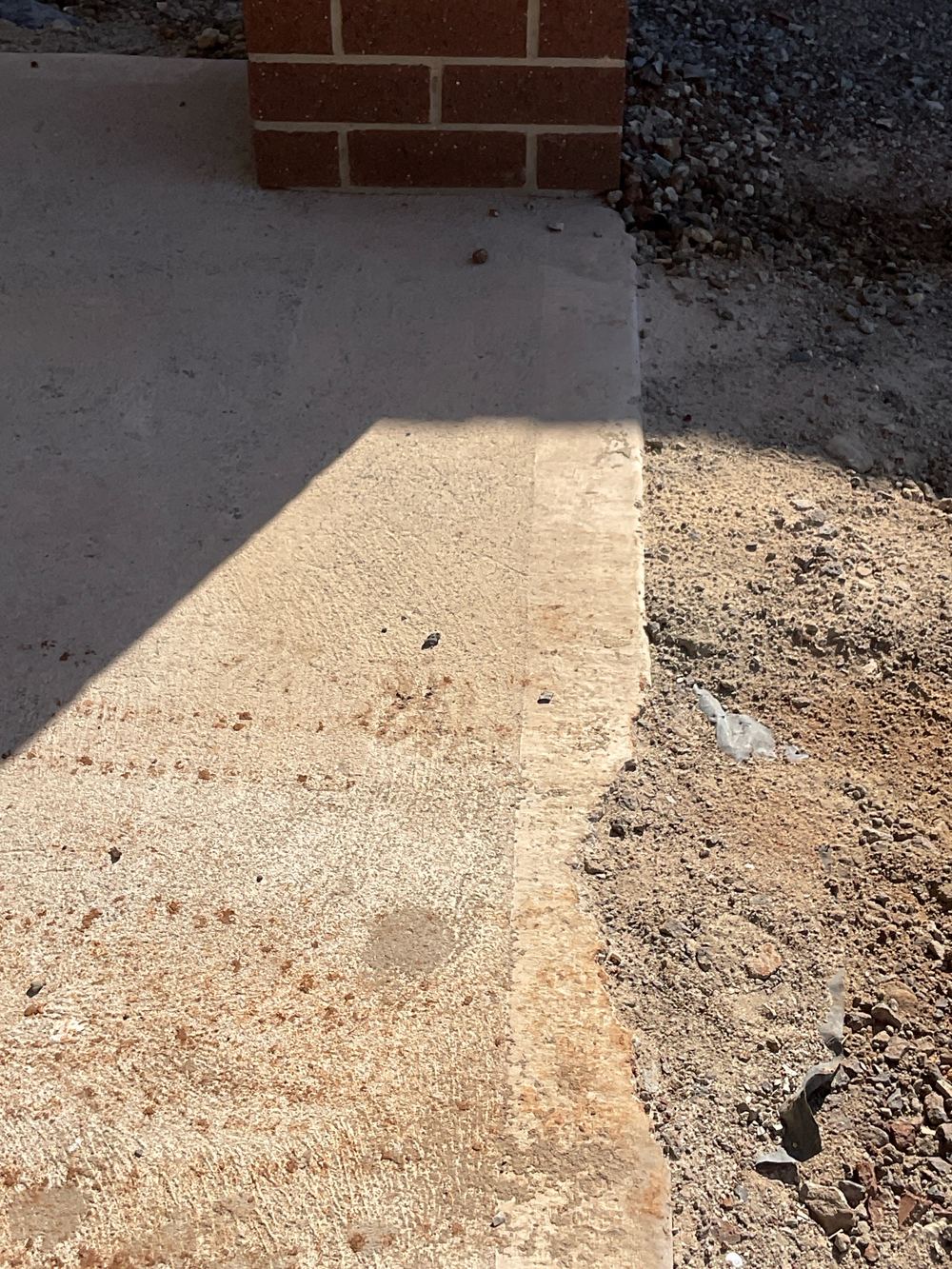 Chipped edge on the new concrete path beside the house, Aintree, Deanside