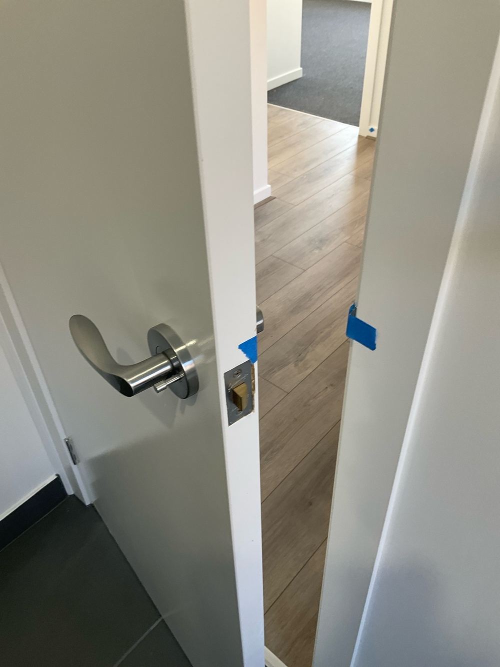 Latch missing the striker plate, so the door will not stay shut, found during a pre-handover inspection in Aintree